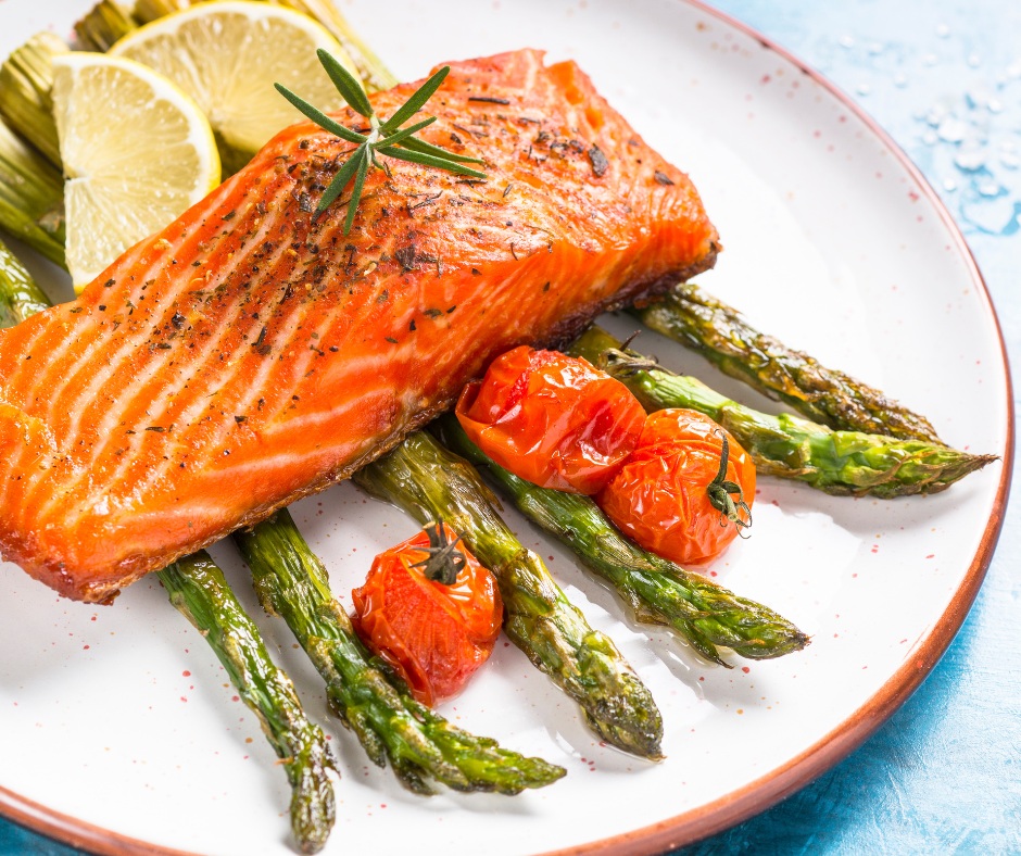 A beautifully plated serving of the garlic butter salmon and asparagus, garnished with lemon slices and fresh herbs. This image should showcase the vibrant colors and presentation of the meal.