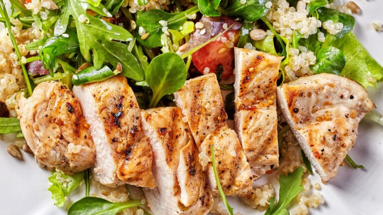 A delicious gluten-free meal featuring fresh vegetables, grilled chicken, and quinoa on a bright, inviting kitchen table.