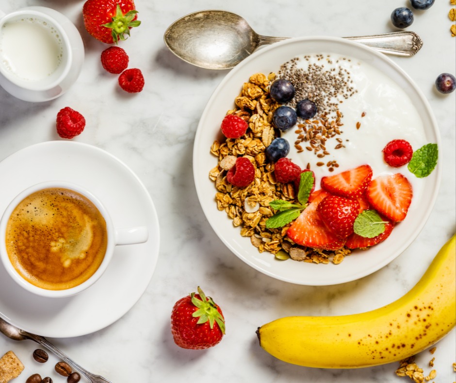  A close-up image of a healthy breakfast spread, including whole grains, fruits, nuts, and a glass of water. 