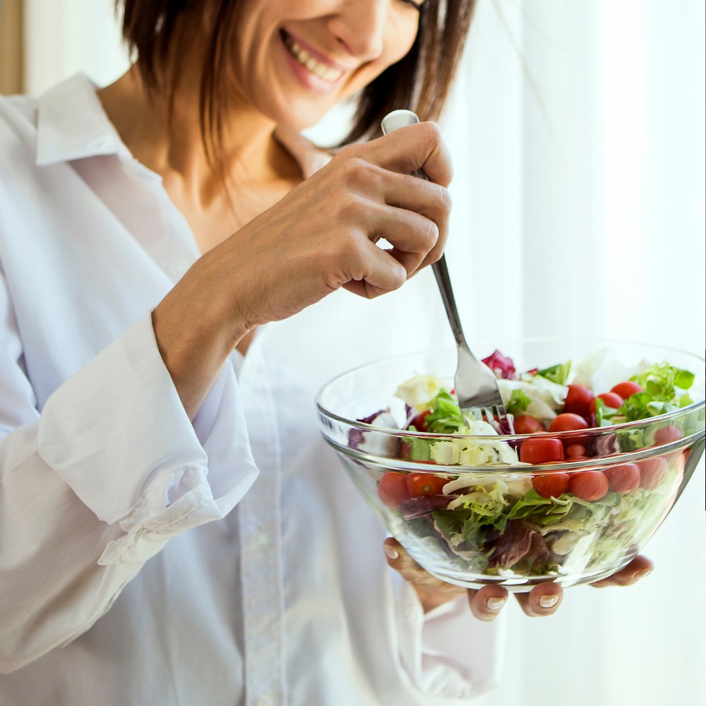 A person slowly savoring a healthy meal, with a focus on the vibrant colors and textures of the food.