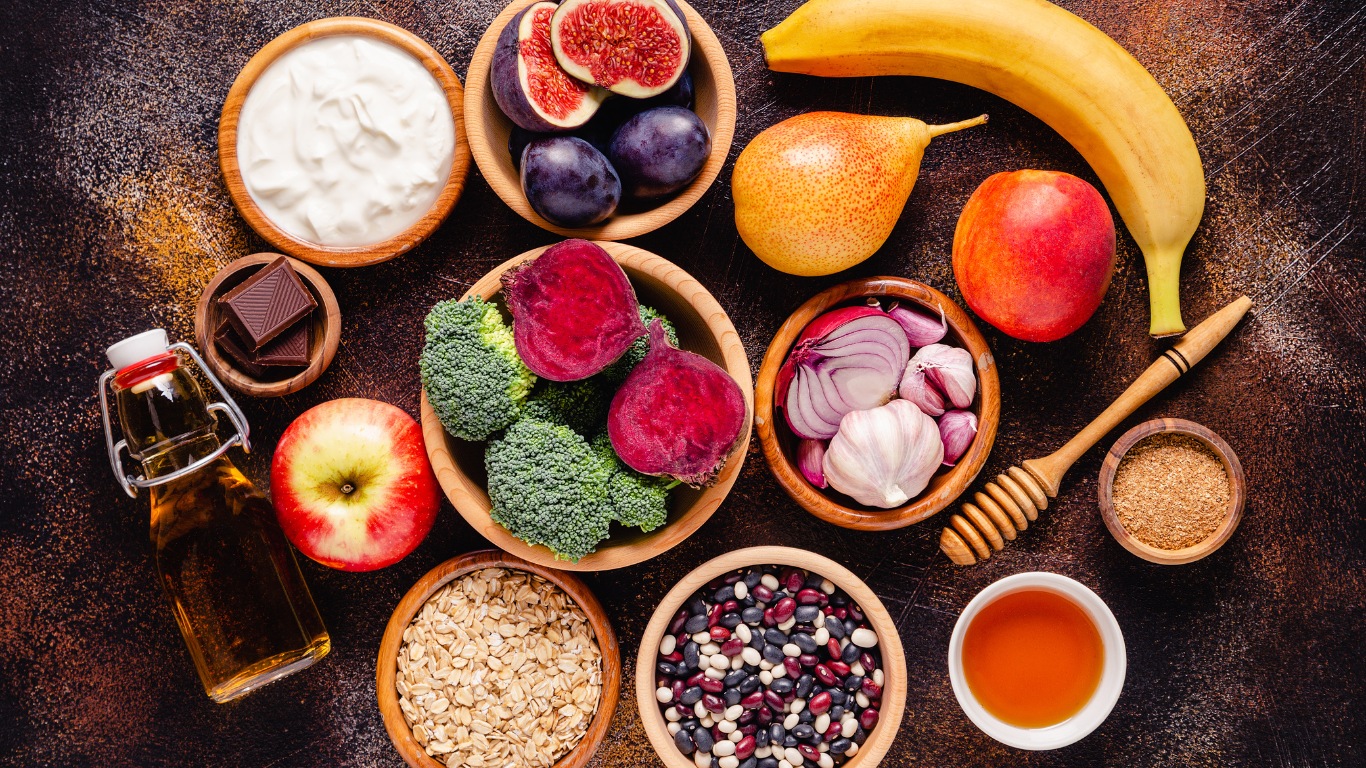gut friendly food A colorful assortment of gut-friendly foods, including yogurt, leafy greens, nuts, and fruits, highlighting their benefits for gut health and glowing skin.