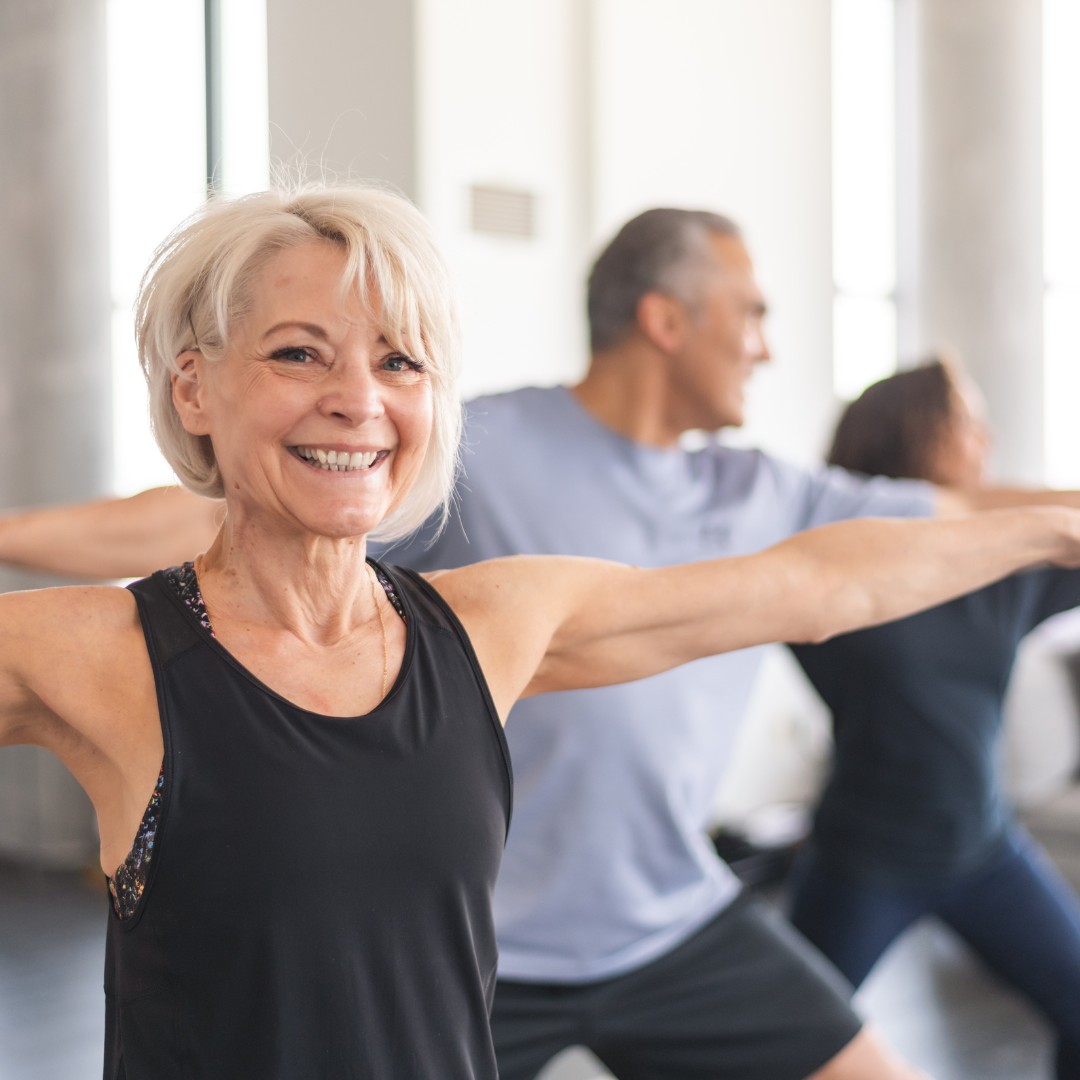 Group of seniors practicing yoga together, enjoying both physical and social benefits of exercise."