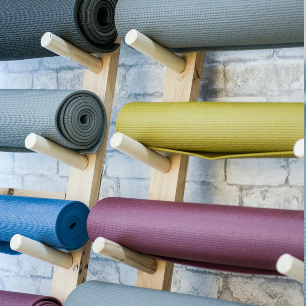 Comparison of eco-friendly yoga mats made from sustainable materials like cork alongside synthetic PVC mats, highlighting the issue of greenwashing in yoga products.