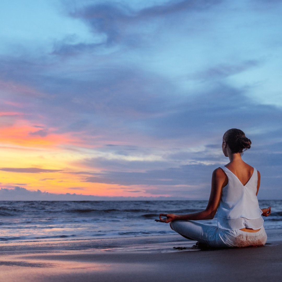 Person practicing yoga outdoors for self-care and relaxation