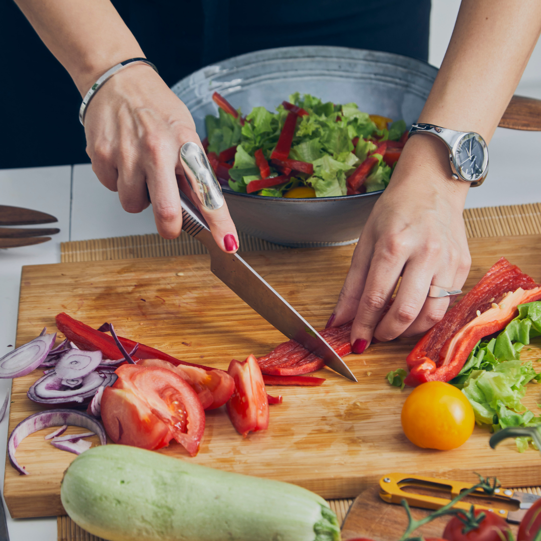 A person preparing a fresh salad with whole foods in a cozy kitchen setting.