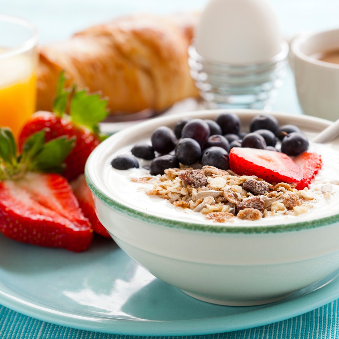 A healthy breakfast setup with fruit, tea, and a notebook, symbolizing a productive morning.