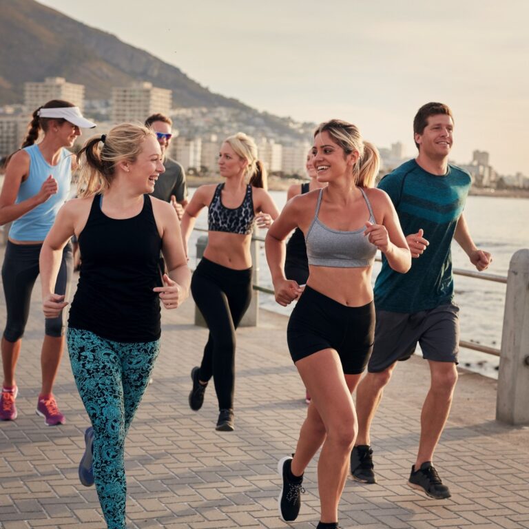 Diverse group of individuals participating in cardio, strength training, and yoga in a park