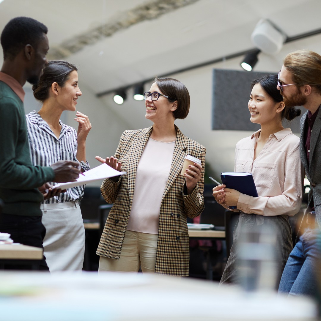 A diverse team collaborating in a positive work environment, symbolizing workplace mental health.