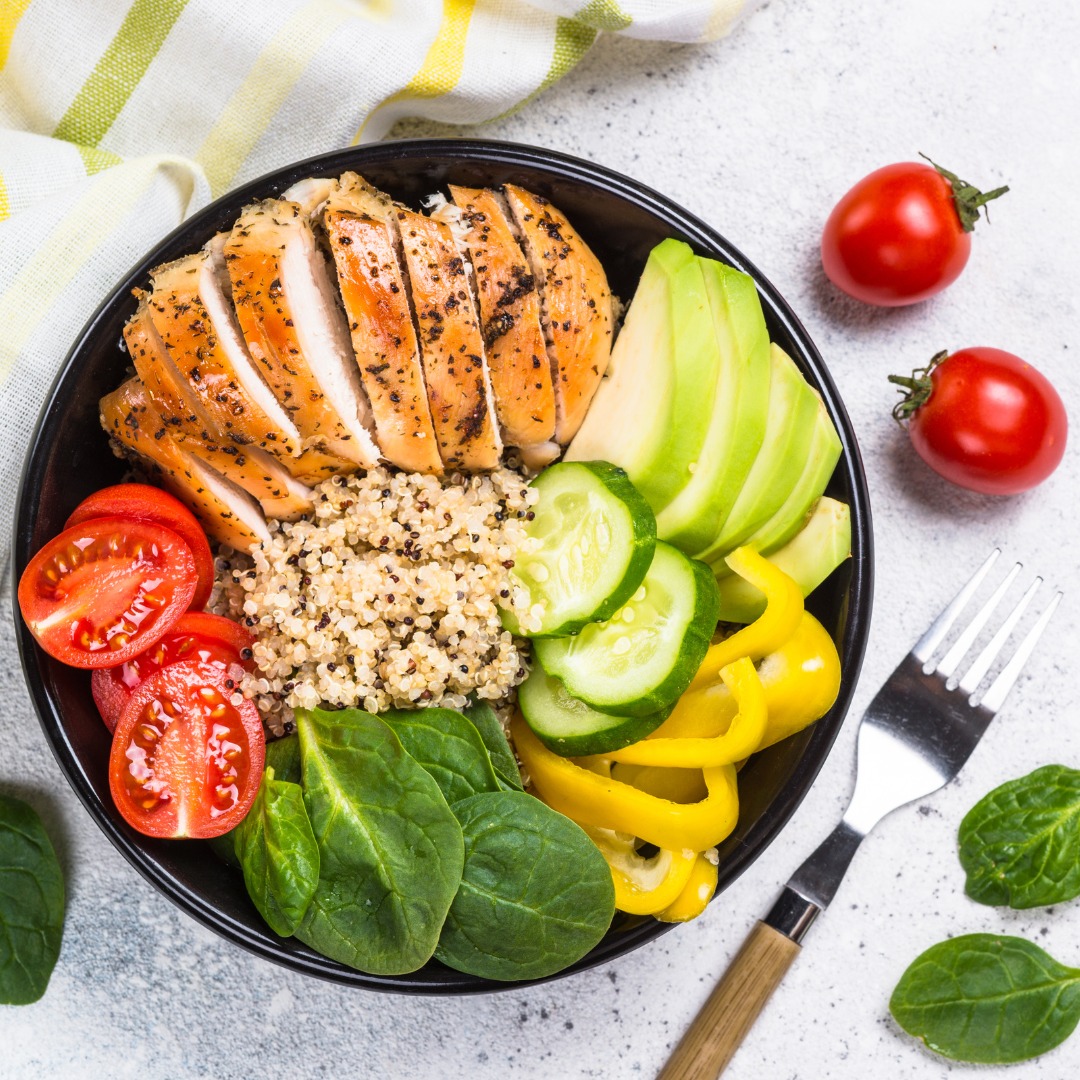 A high-protein meal featuring grilled chicken breast, roasted vegetables, and quinoa, symbolizing a balanced diet.