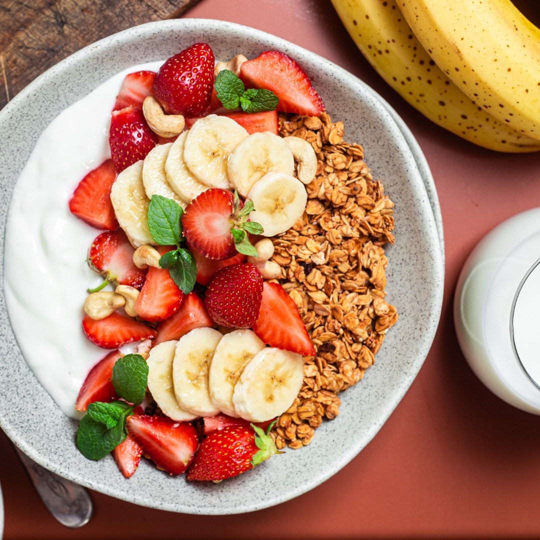 A protein-rich breakfast featuring Greek yogurt, fresh berries, chia seeds, and granola.