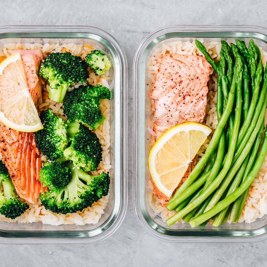 Meal prep containers with baked salmon, steamed broccoli, and brown rice, highlighting preparation for a high-protein diet.