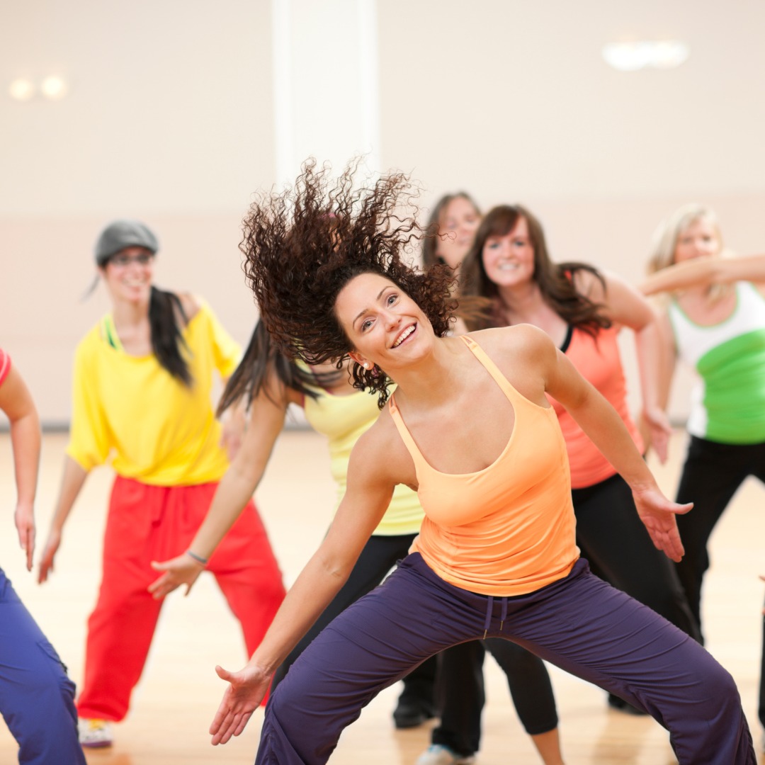 Participants in a dance fitness class, highlighting the fun and community aspect of fitness.