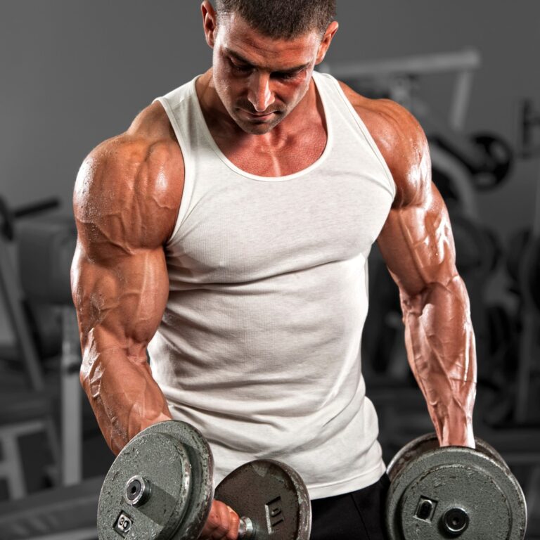 Person performing bicep curls for sculpted arms in a gym.