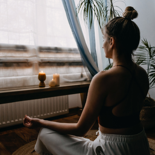 Person practicing mindfulness meditation in nature.