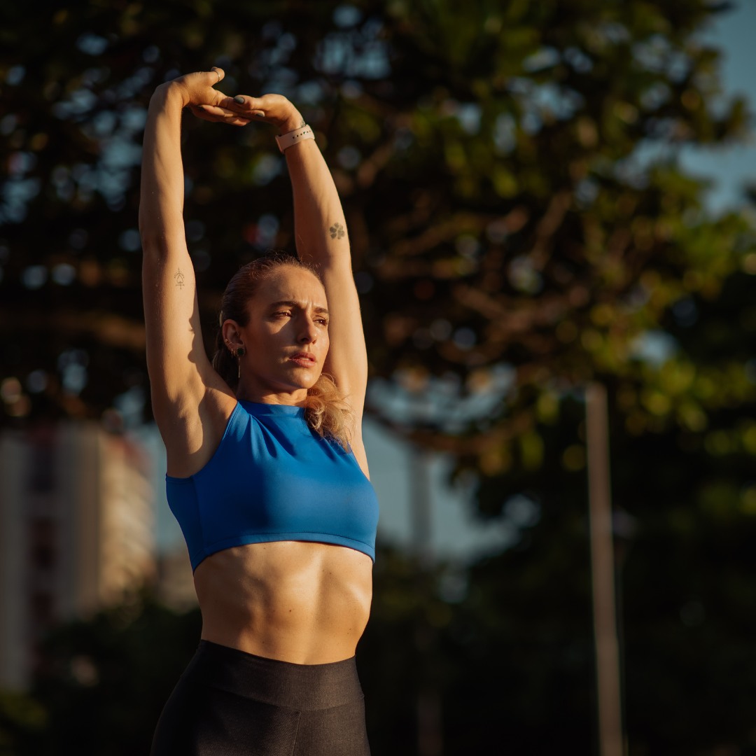 A dynamic image of a person performing a full-body stretch in a serene outdoor setting, highlighting the benefits of stretching for both mental and physical health.