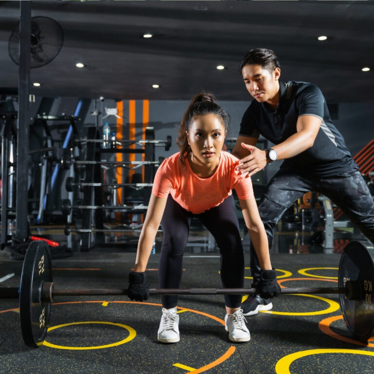 Trainer demonstrating correct squat technique.