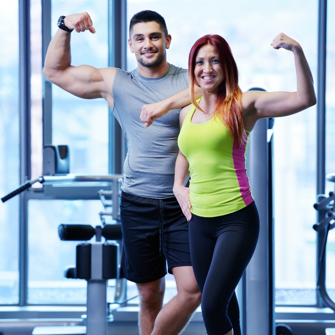 Person smiling while exercising at home with motivational quotes.