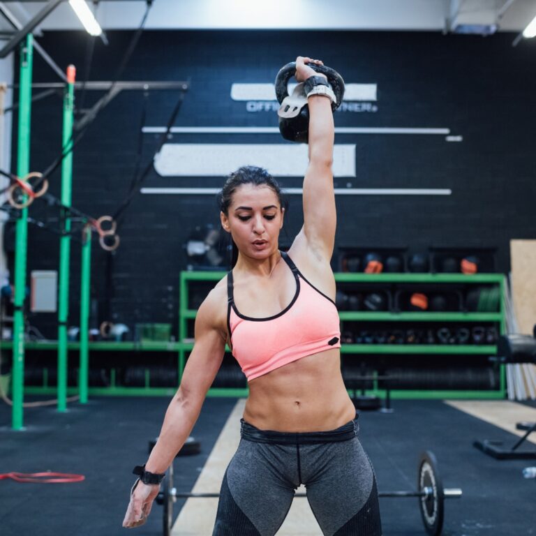 Athlete performing a kettlebell swing, showcasing strength and endurance