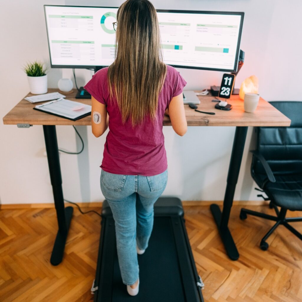 Standing desk with ergonomic workspace and exercise equipment.