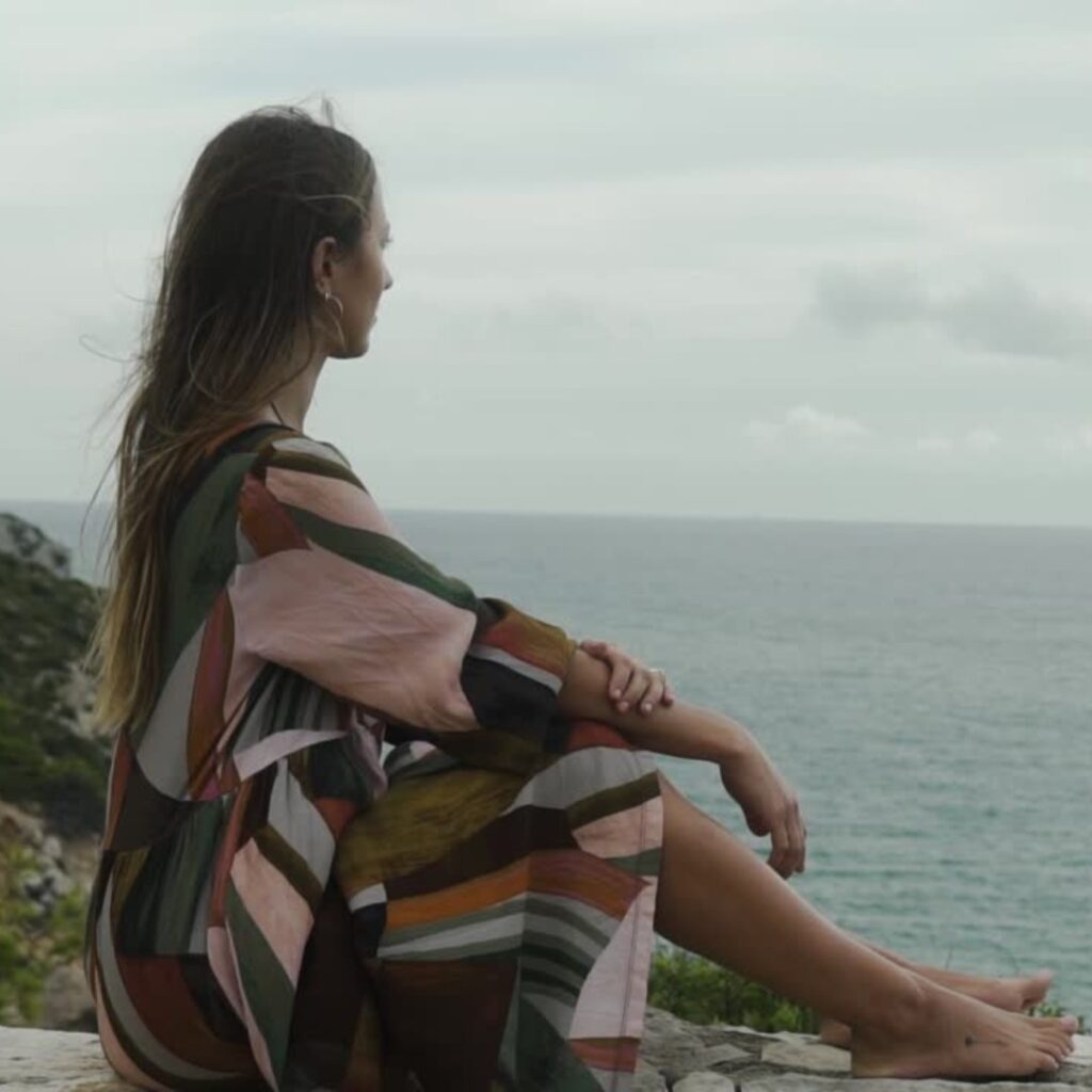 Relaxed individual enjoying a peaceful moment in nature during a digital detox