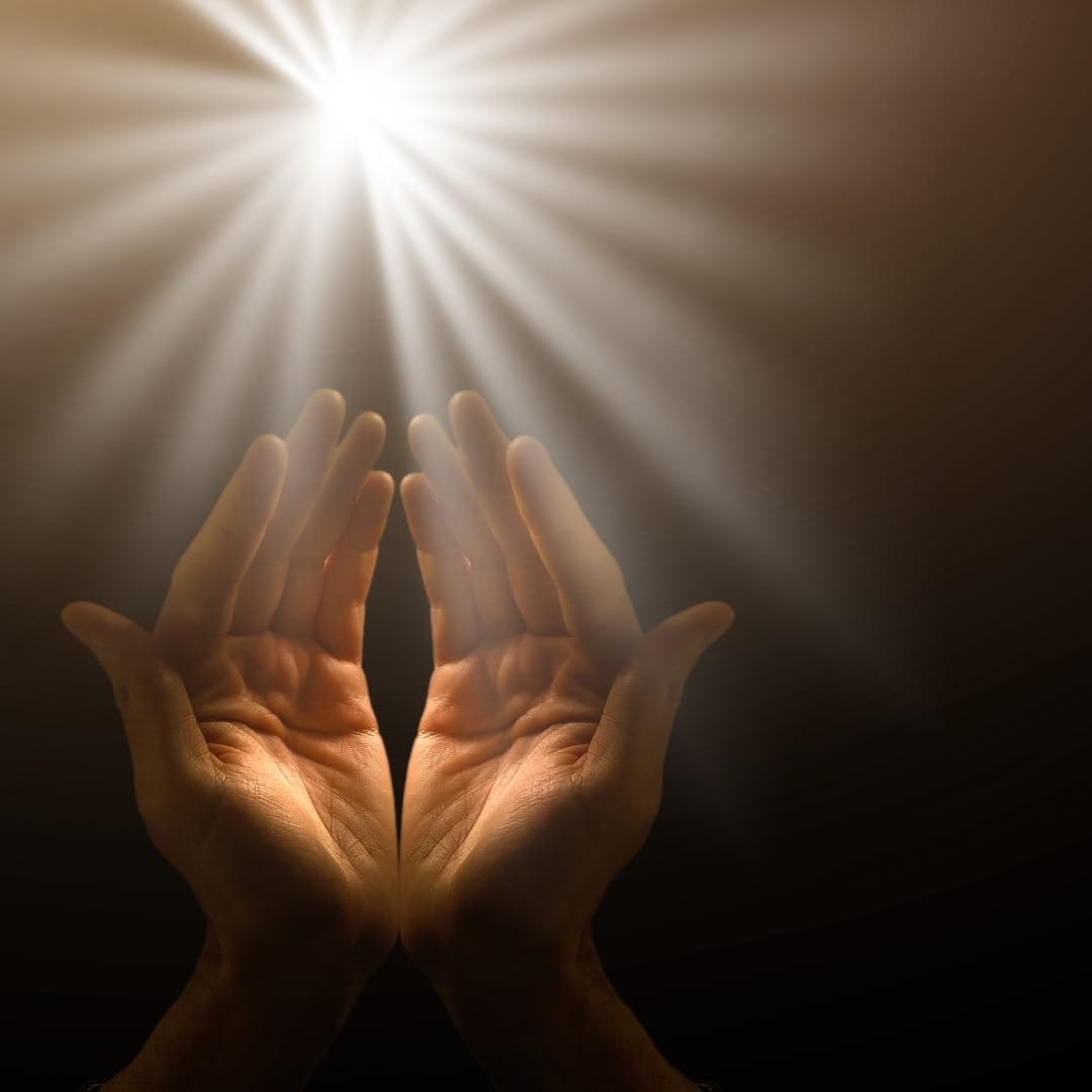 Close-up of hands clasped in prayer with sunlight Hands clasped in prayer, symbolizing faith and resilience during recovery.